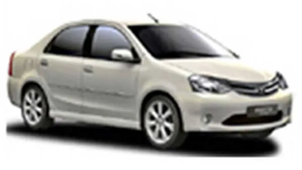 White Toyota Etios sedan parked on a road.